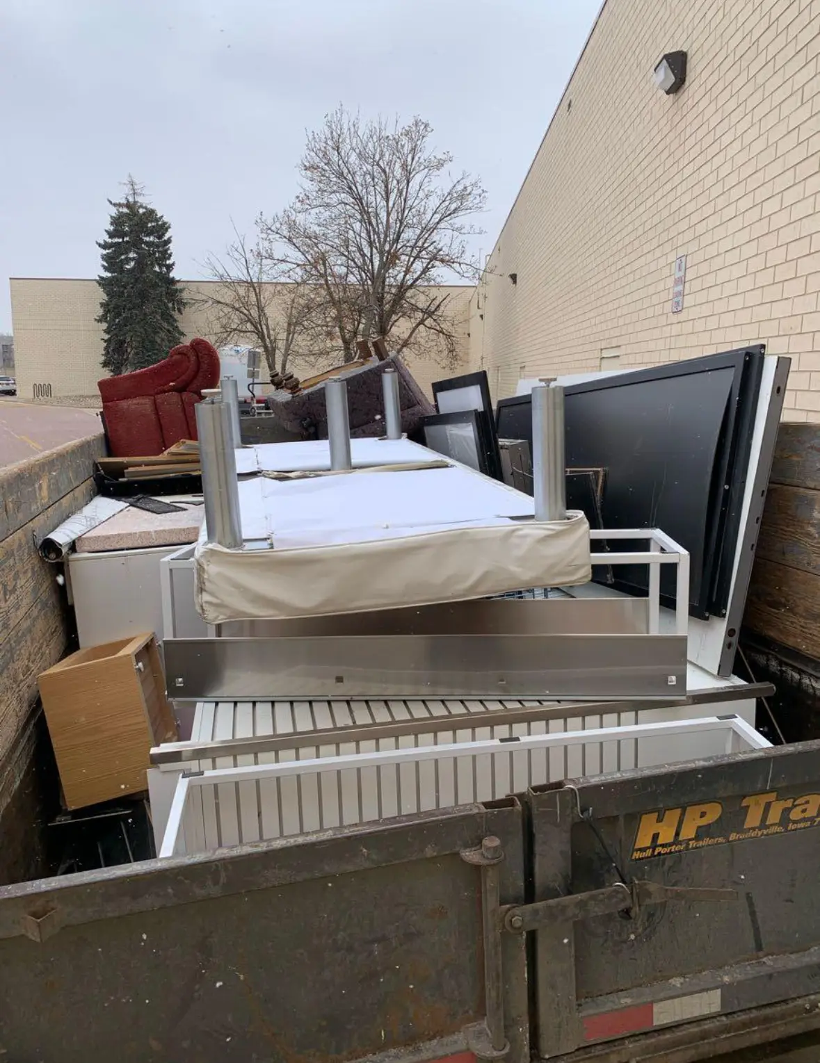 Dump trailer fully loaded with furniture and household junk